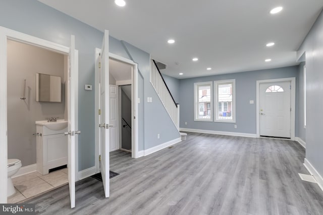 foyer entrance with sink and light hardwood / wood-style floors