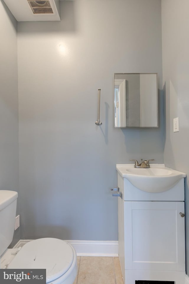 bathroom featuring vanity, tile patterned flooring, and toilet