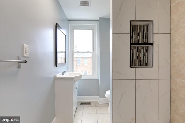 bathroom featuring vanity, toilet, and tile patterned flooring