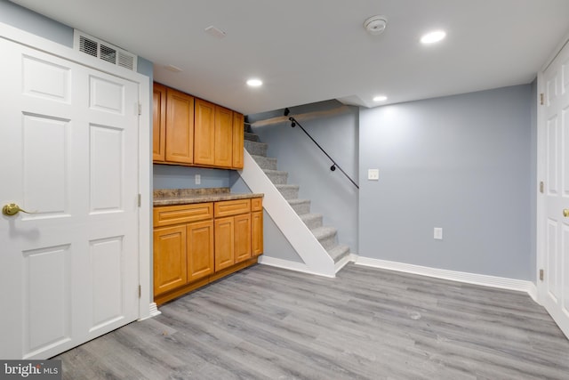 basement featuring light wood-type flooring