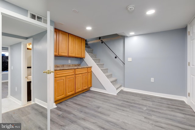 bar with light hardwood / wood-style flooring