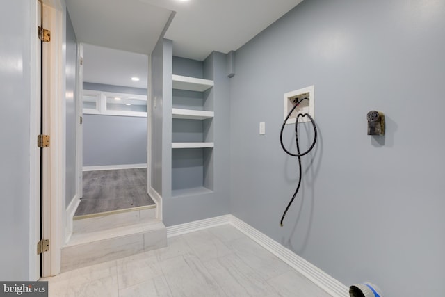 interior space featuring built in shelves and hookup for a washing machine