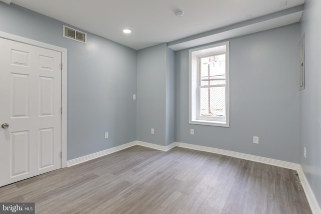 empty room with light hardwood / wood-style flooring