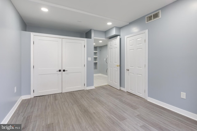 unfurnished bedroom with light wood-type flooring