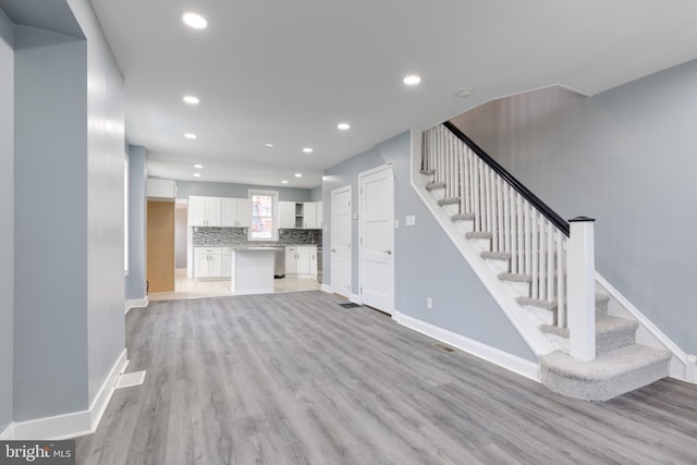 unfurnished living room with light hardwood / wood-style floors