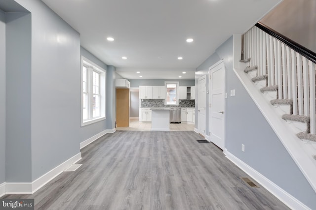 unfurnished living room featuring light wood-type flooring