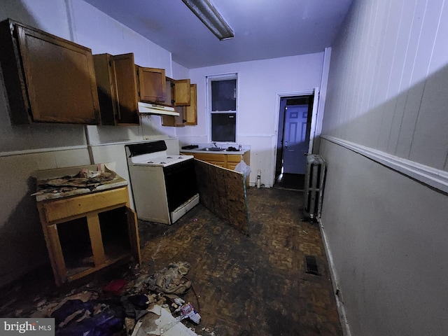 kitchen with radiator heating unit, white electric stove, and sink