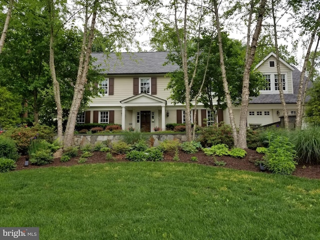 view of front of home with a garage and a front yard