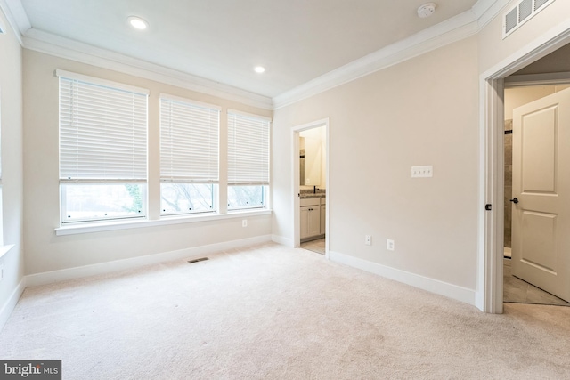 unfurnished bedroom with ornamental molding, light carpet, visible vents, and baseboards