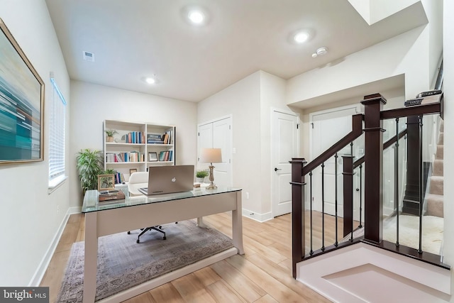 office space with baseboards, wood finished floors, and recessed lighting