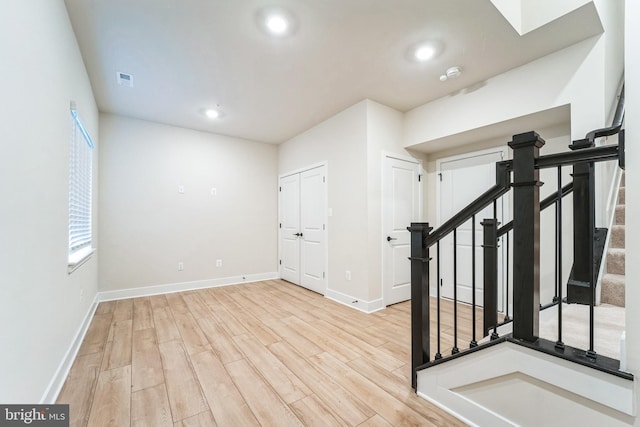 interior space with stairs, recessed lighting, wood finished floors, and baseboards