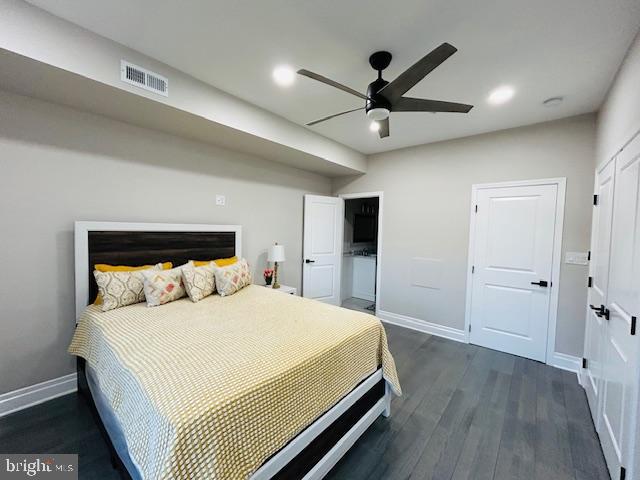 bedroom with dark hardwood / wood-style floors and ceiling fan