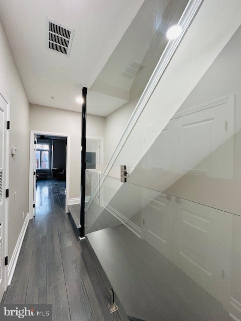 corridor with dark hardwood / wood-style floors