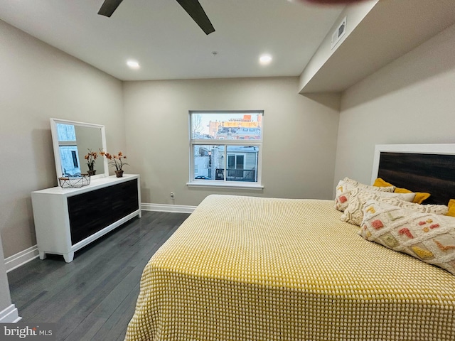 bedroom with multiple windows, dark hardwood / wood-style floors, and ceiling fan