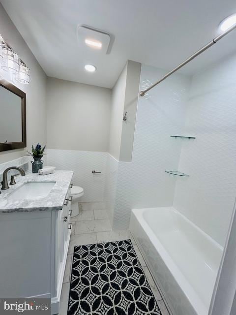 full bathroom with washtub / shower combination, vanity, and toilet