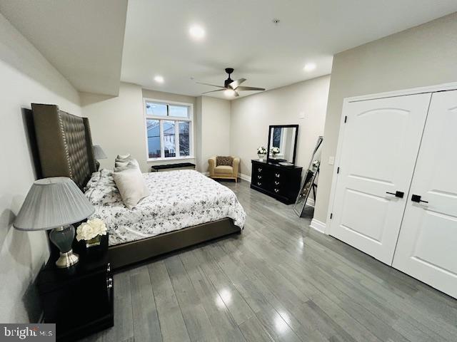 bedroom with hardwood / wood-style floors and ceiling fan