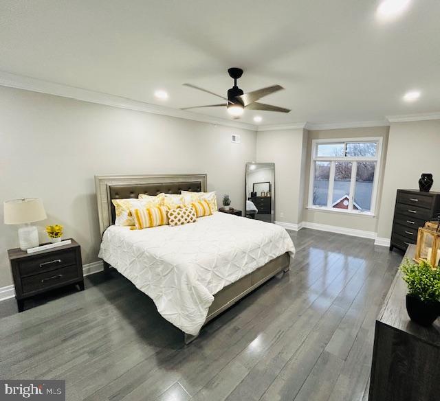 bedroom with ornamental molding, dark hardwood / wood-style floors, and ceiling fan