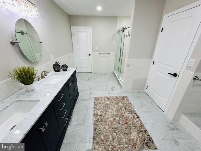 bathroom featuring vanity and an enclosed shower