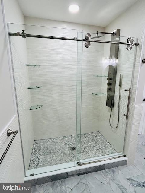 bathroom with a shower with shower door