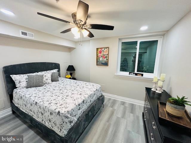 bedroom with hardwood / wood-style flooring and ceiling fan