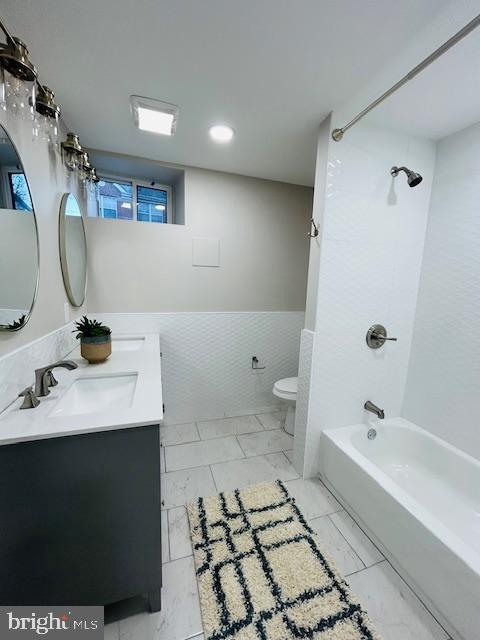 full bathroom with vanity, shower / bathtub combination, and toilet