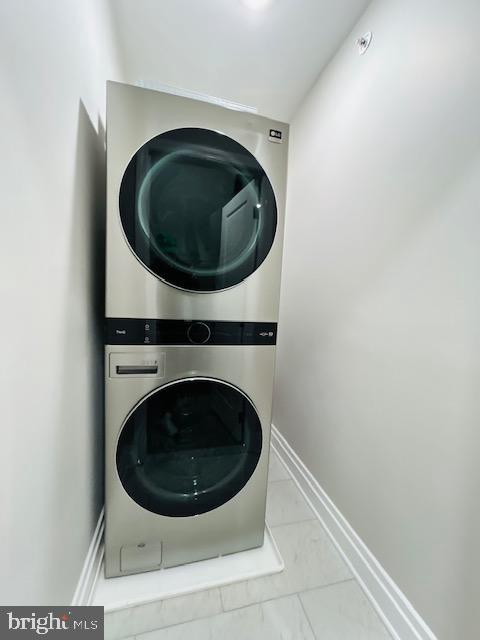 laundry room featuring stacked washing maching and dryer