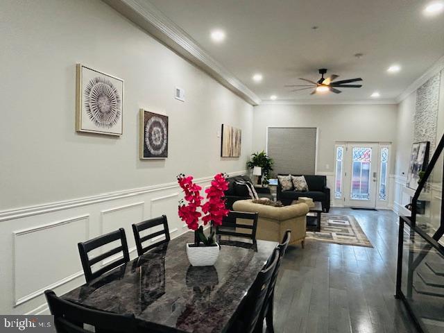 dining room featuring crown molding, dark hardwood / wood-style floors, and ceiling fan