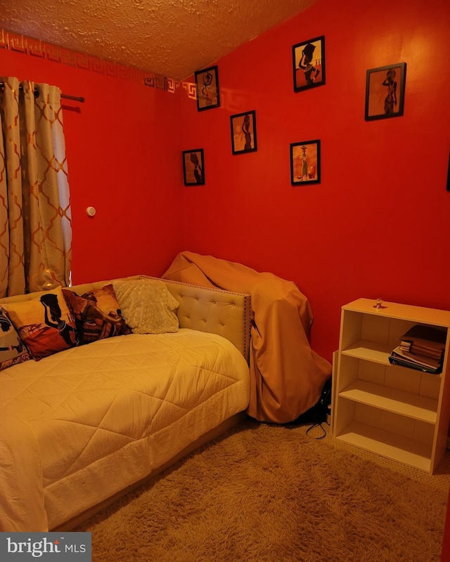 bedroom with carpet flooring and a textured ceiling