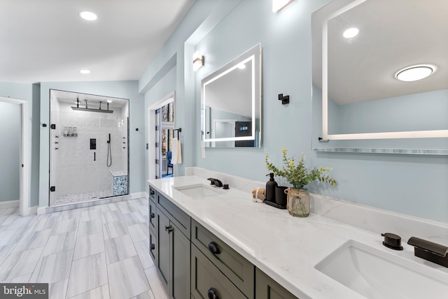 full bathroom with a stall shower, a sink, recessed lighting, and double vanity