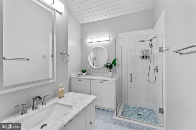 full bathroom with a stall shower, marble finish floor, two vanities, and a sink