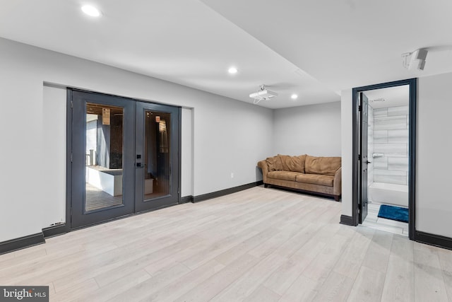 sitting room featuring french doors, light wood-type flooring, and recessed lighting