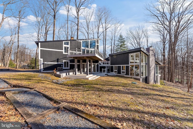 view of front of property featuring a chimney and a deck