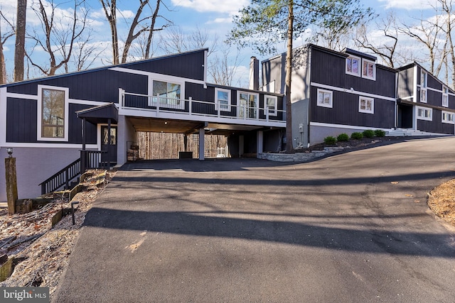 view of front of property with a carport and driveway