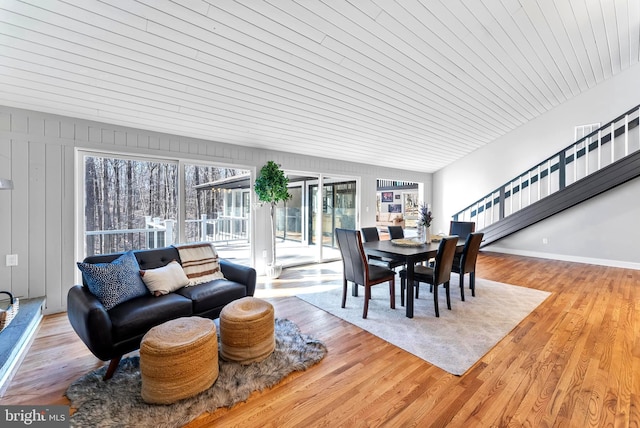 dining space with baseboards and wood finished floors