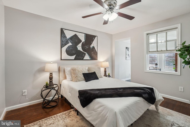 bedroom with ceiling fan and dark hardwood / wood-style floors