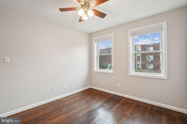 empty room with ceiling fan and dark hardwood / wood-style floors