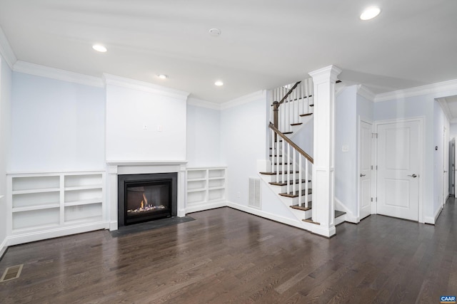 unfurnished living room featuring dark wood-style flooring, a fireplace with flush hearth, and ornamental molding