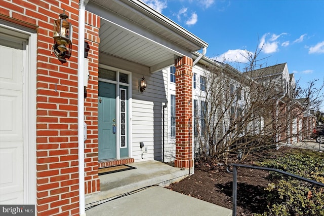 property entrance with brick siding