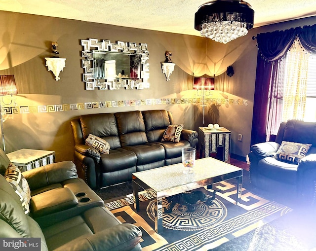 living room featuring a notable chandelier and a textured ceiling