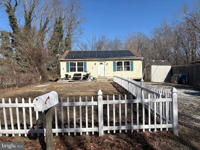 view of front facade with a storage unit and solar panels