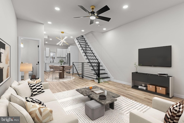 living room featuring ceiling fan and light wood-type flooring