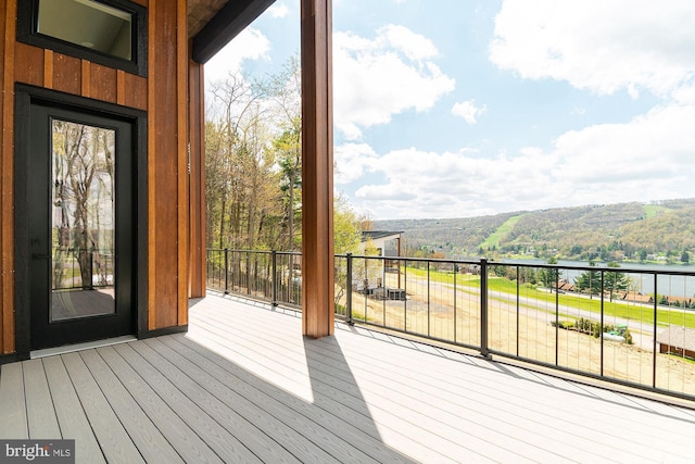 wooden terrace featuring a water view