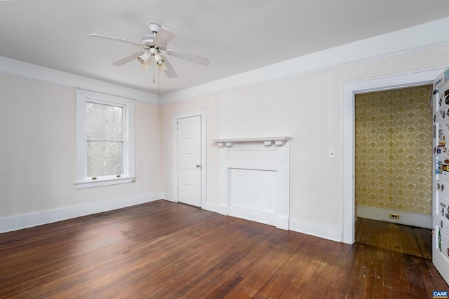 unfurnished room featuring a ceiling fan, baseboards, and dark wood-style flooring