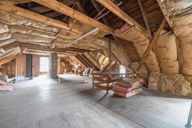 unfinished attic featuring an upstairs landing