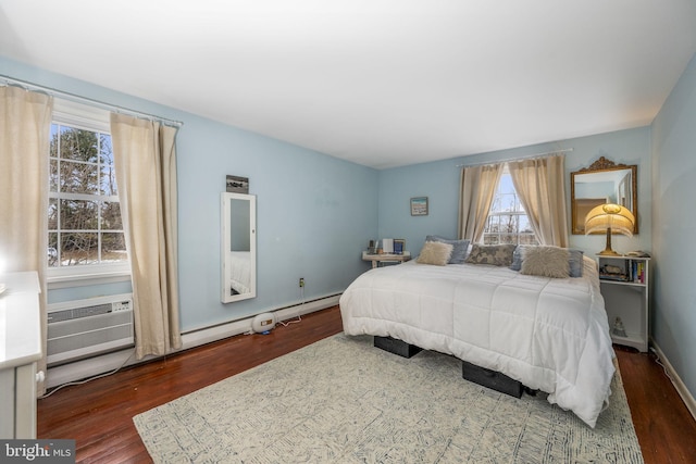 bedroom with dark wood-type flooring and a wall unit AC