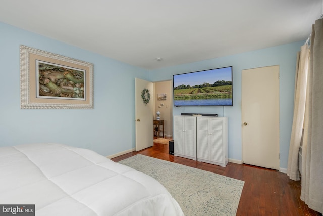 bedroom with dark wood-type flooring