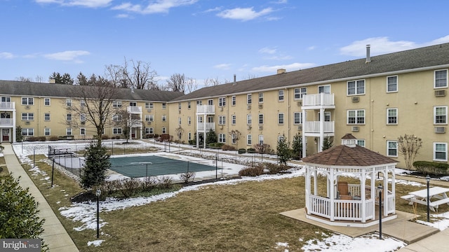 snow covered pool featuring a gazebo and a lawn