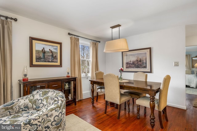 dining area with dark hardwood / wood-style floors