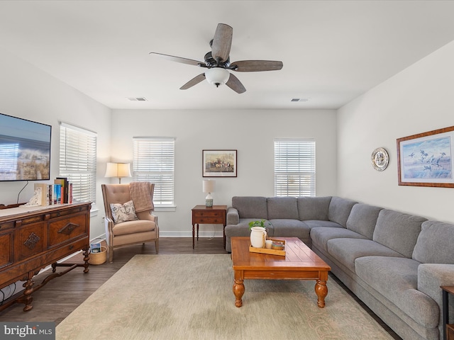 living room featuring dark hardwood / wood-style floors and ceiling fan