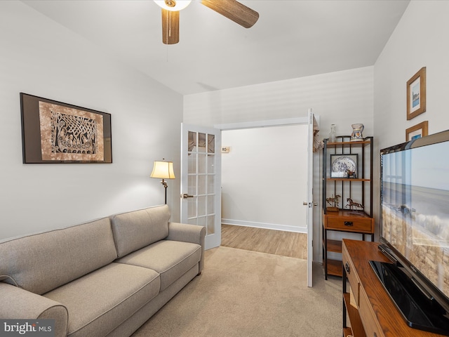 living room with light colored carpet and ceiling fan